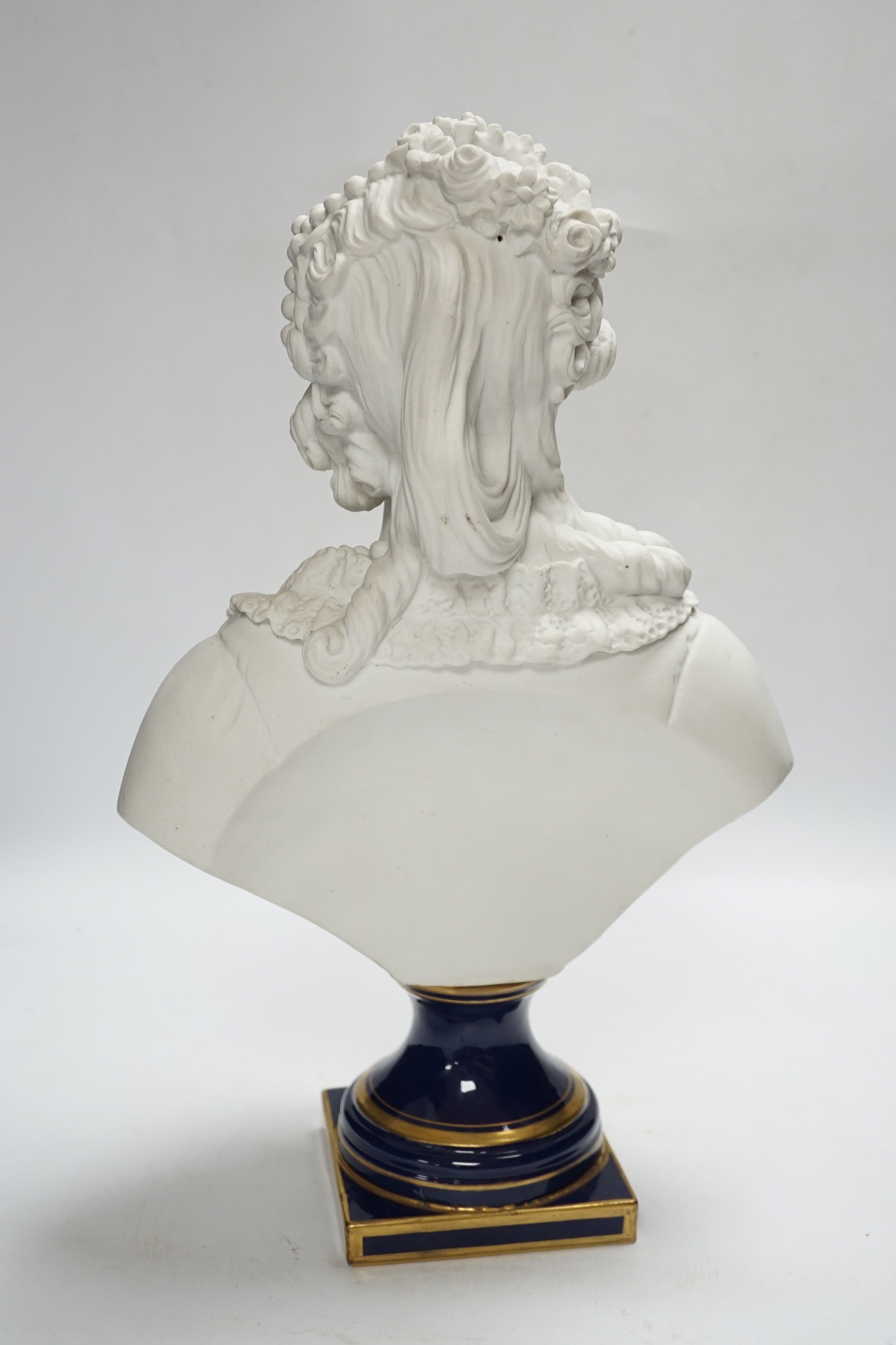 A Sevres style biscuit porcelain bust of a courtesan, 42cm high